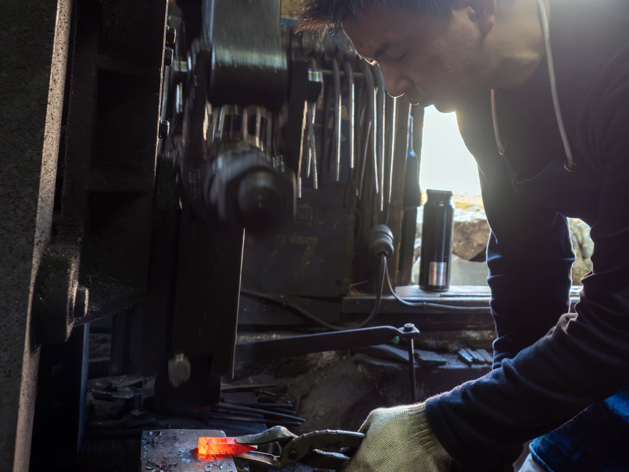 Third-generation master Yoshiyuki Kondo hand-forging a steel stone chisel body at Kondo Stonemason Tools Factory in Okazaki, Japan