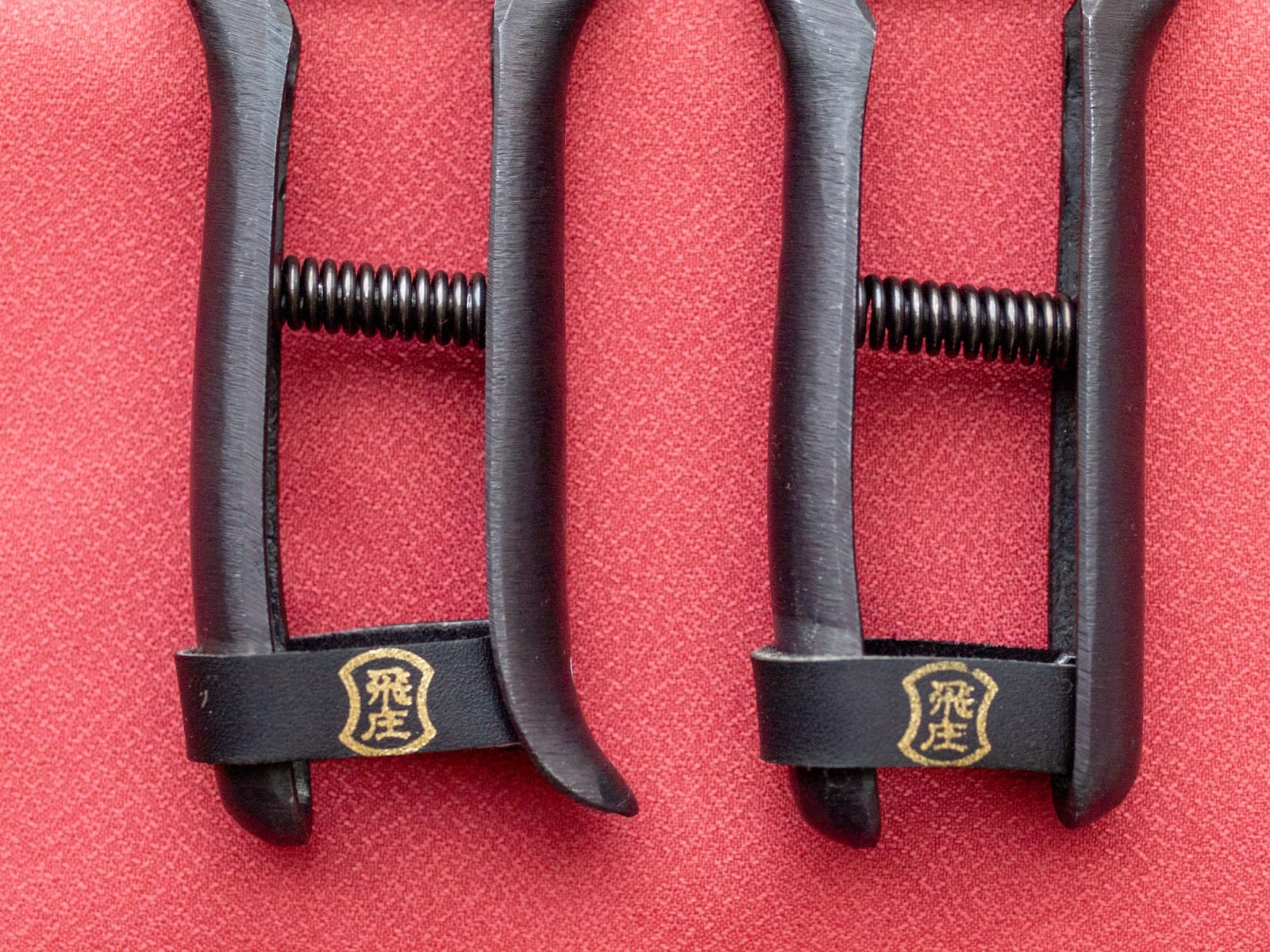 Tobisho Hiryu and Hiryu Alpha pruning shears side by side, comparing the straight and raised-heel handle shapes, forged in Yamagata Japan